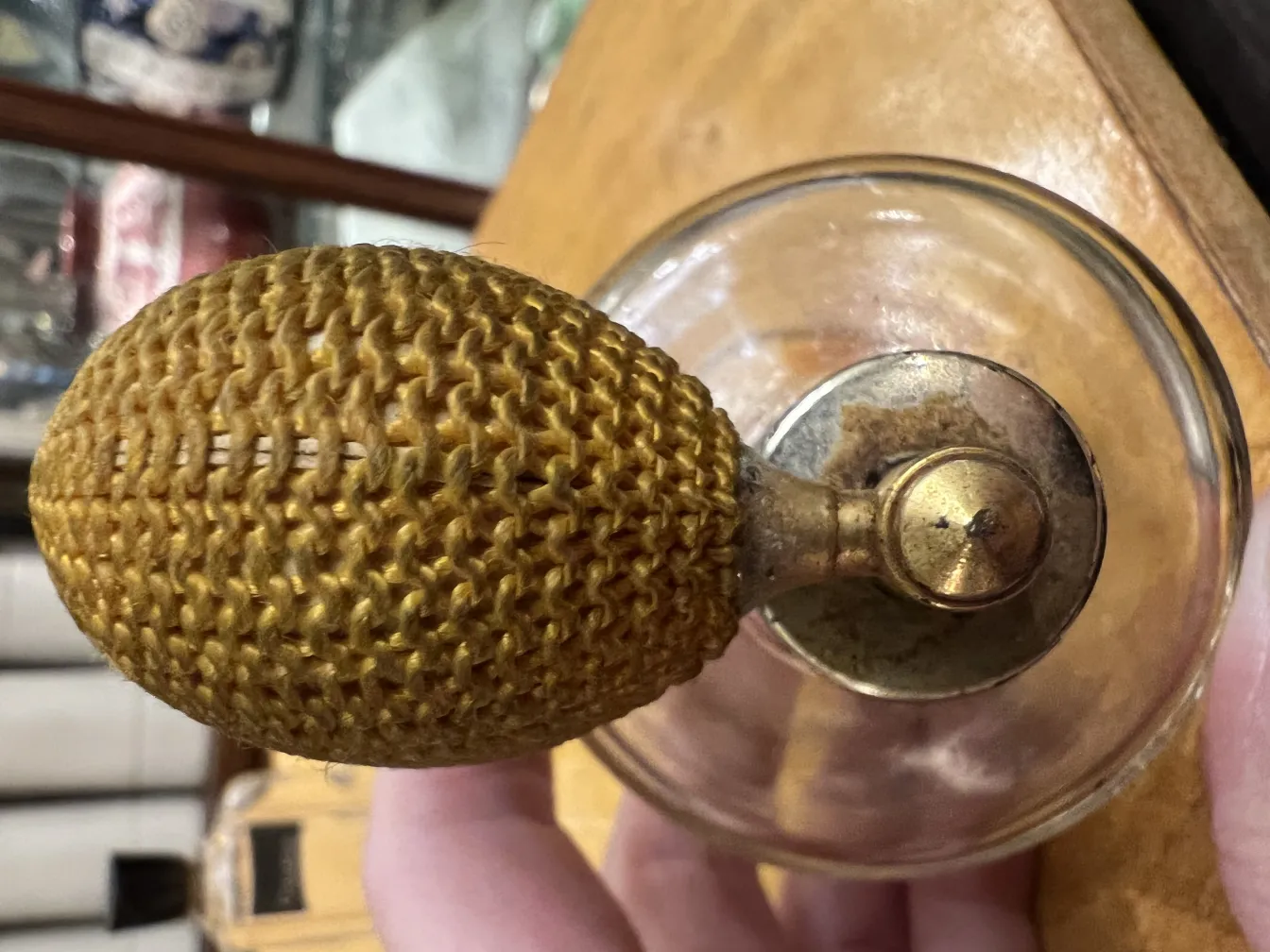 Antique perfume bottle with a golden woven top