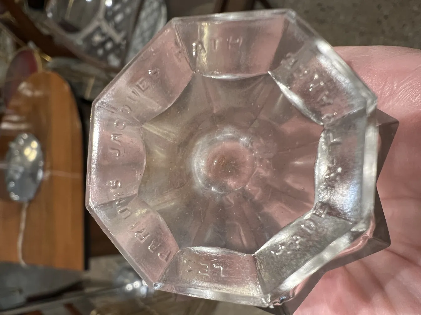 frasco de perfume antiguo con diseño en vidrio octagonal y detalles grabados.