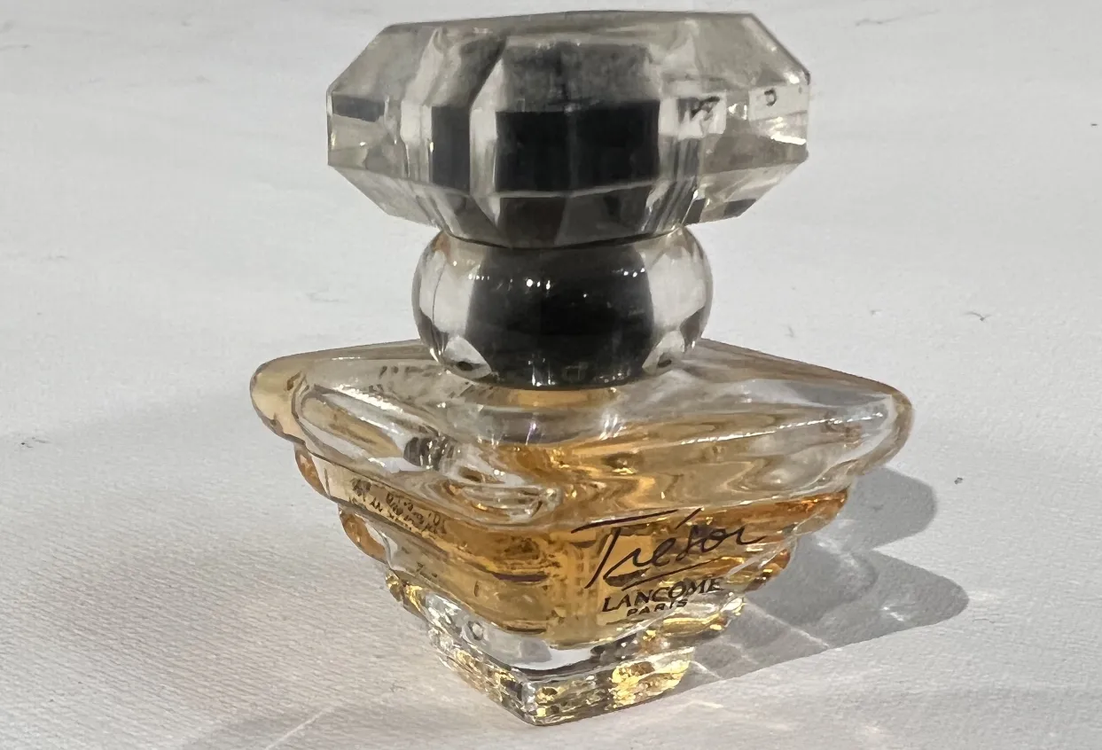 Antique Lancome perfume bottle with elegant shape and crystal details.