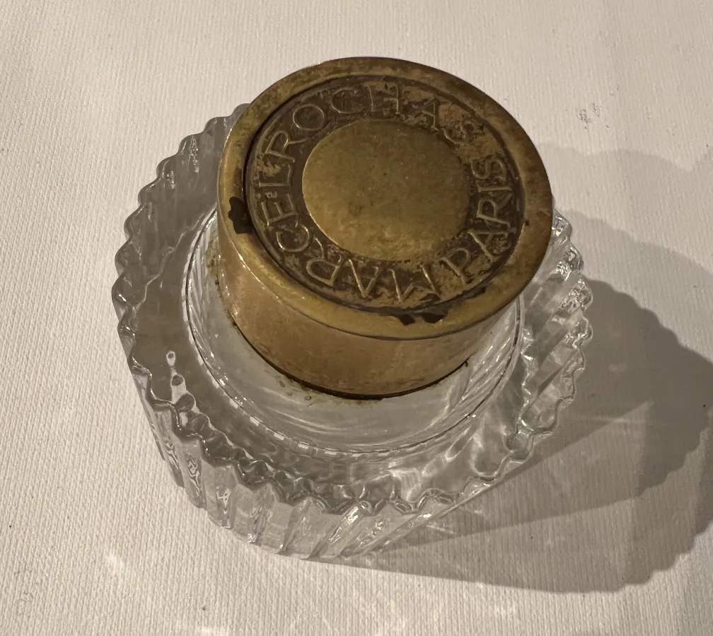 antique perfume bottle with gold lid and engravings