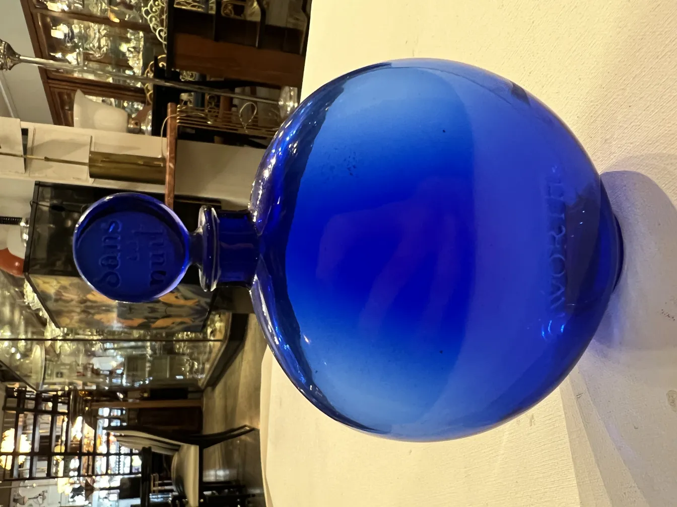 antique blue perfume bottle, round shape with distinctive lid, antique environment.