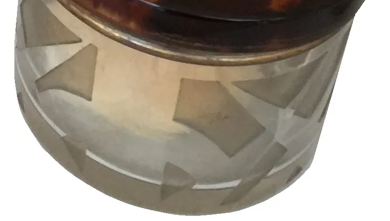 antique perfume bottle with decorative design, part of the setup.