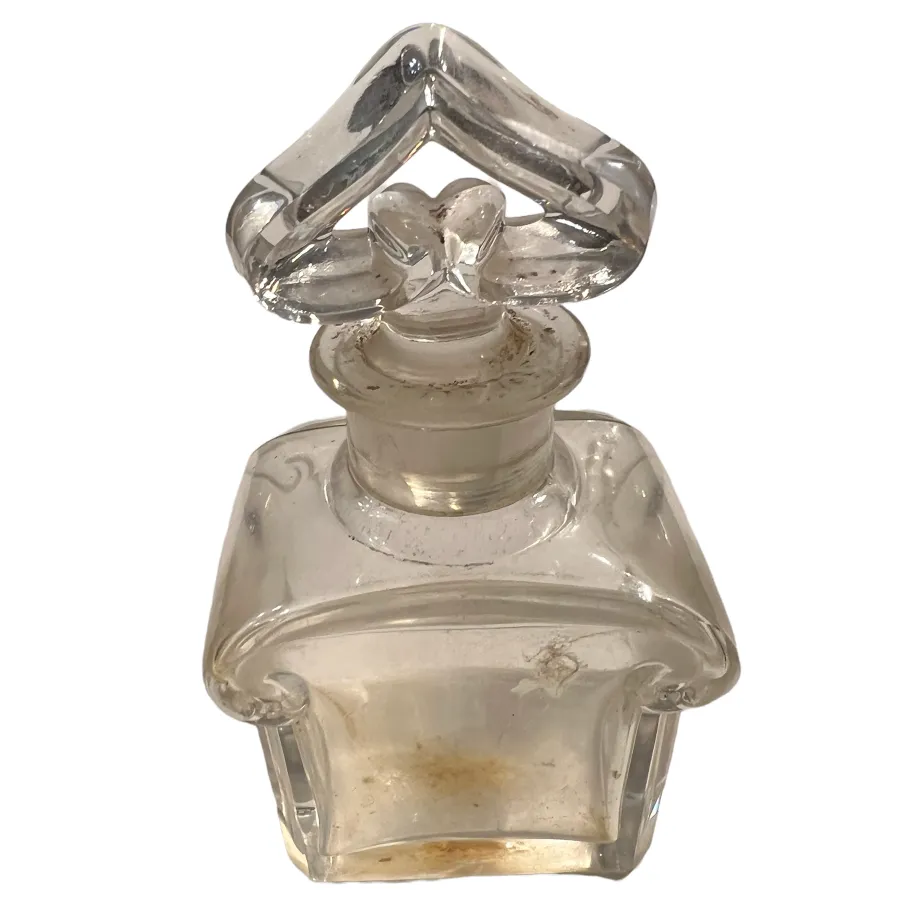 antique perfume bottle with elegant design and heart-shaped stopper, featuring subtle details and a slight patina