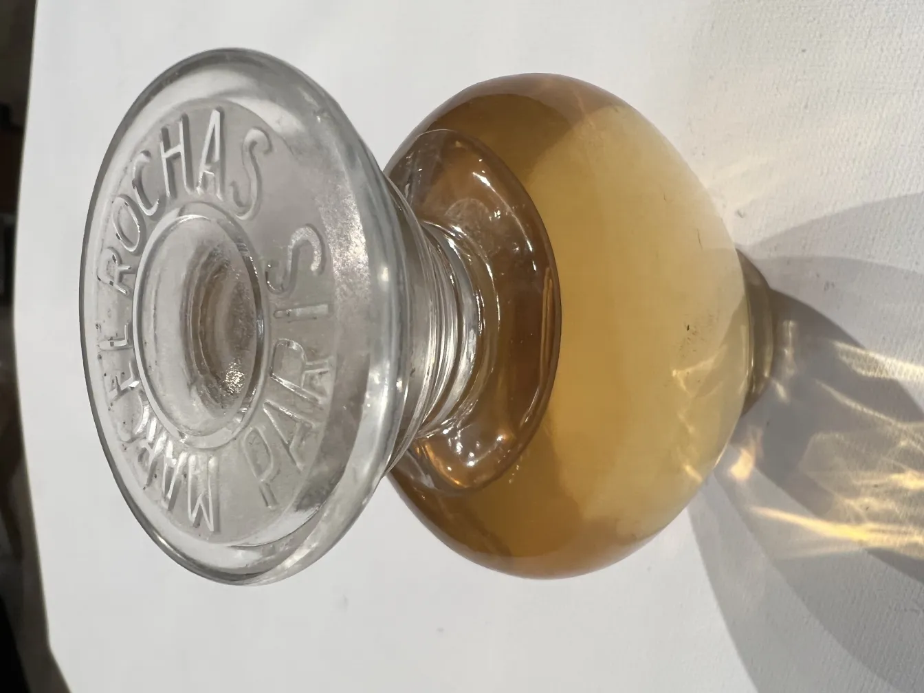 Antique perfume bottle by Rochas, golden liquid inside