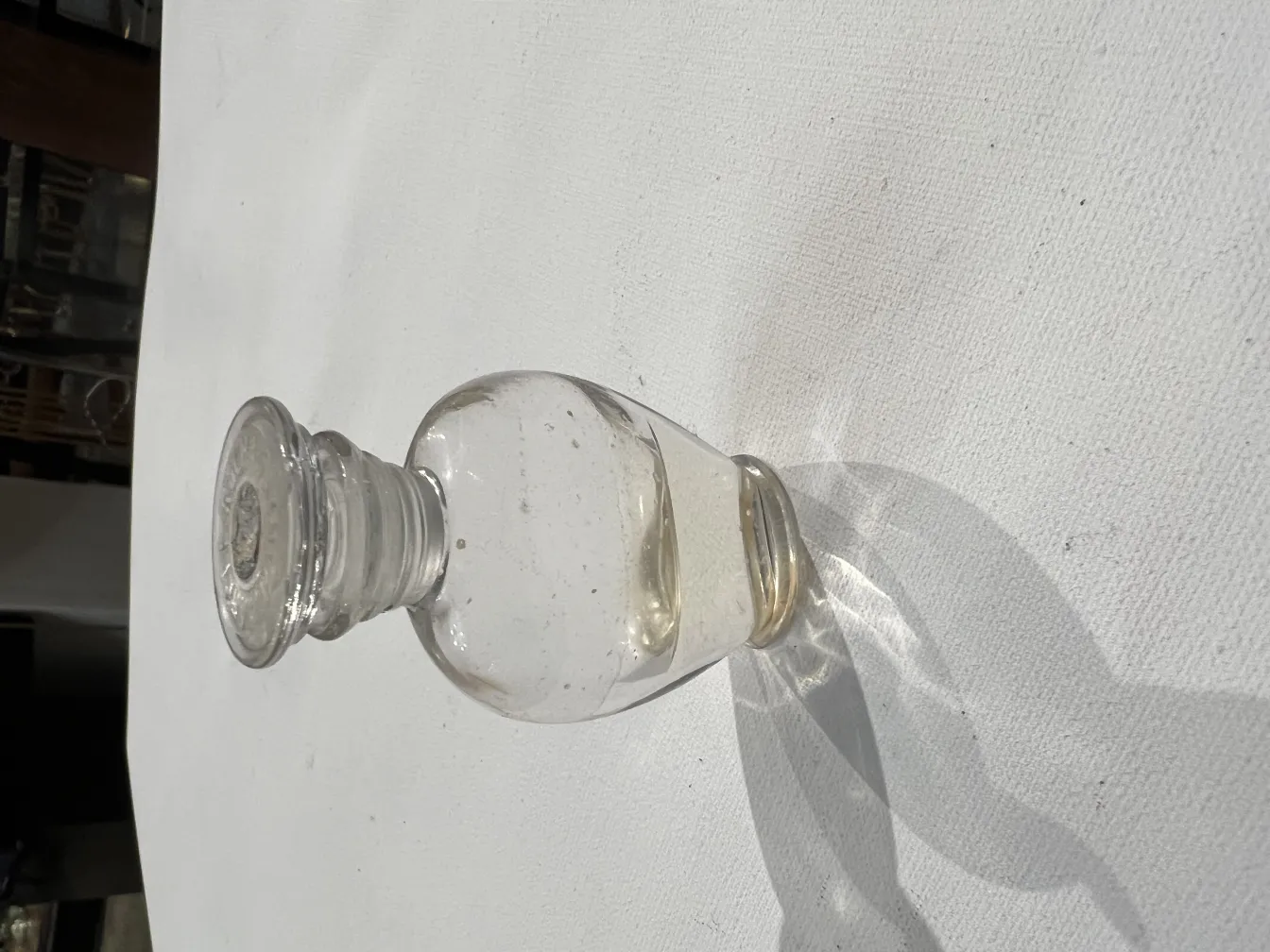 antique transparent perfume bottle on a white table