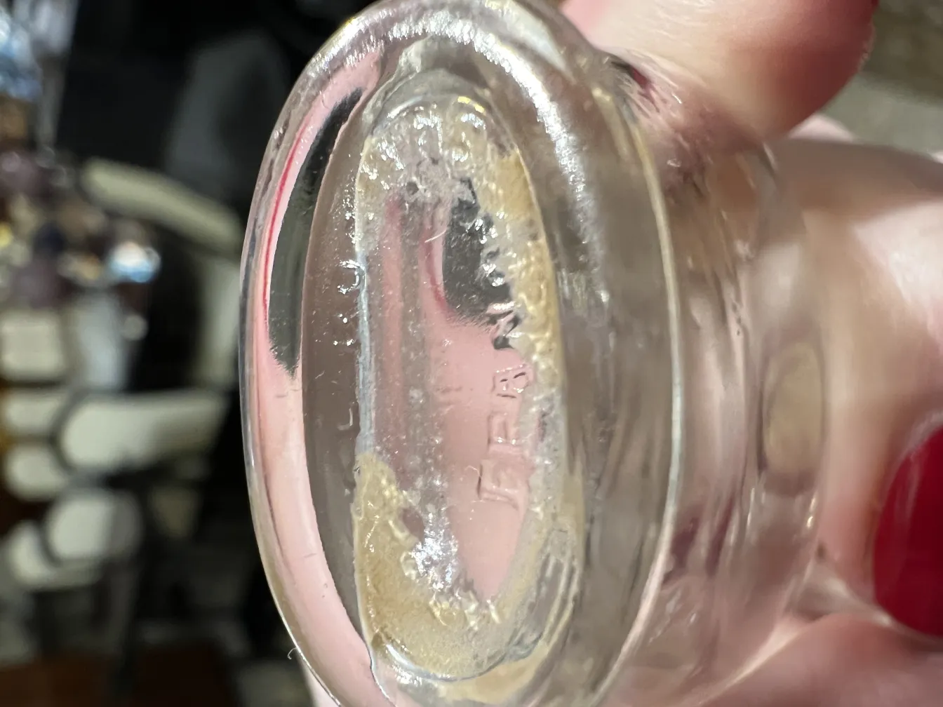 Antique perfume bottle with visible details, blurred background