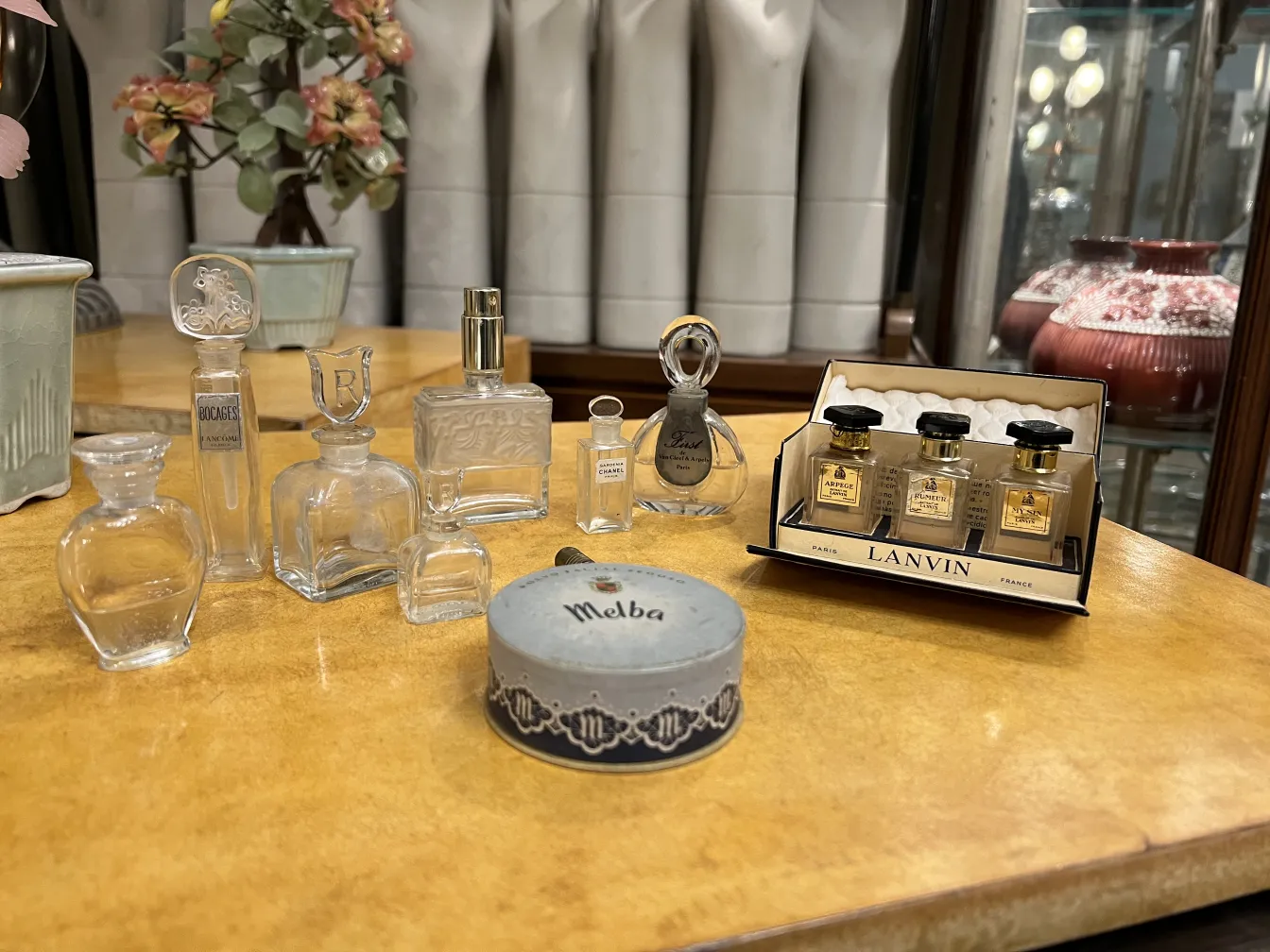 antike Parfümflasche, umgeben von verschiedenen Flaschen in einem eleganten Ambiente