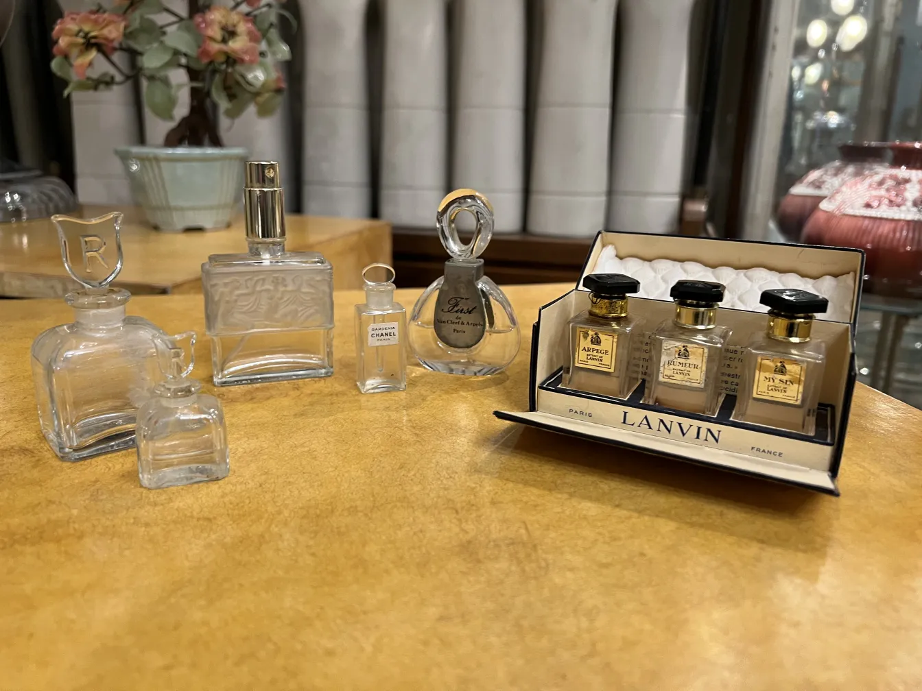 Vários frascos de perfume antigos em diferentes formas e tamanhos sobre a mesa