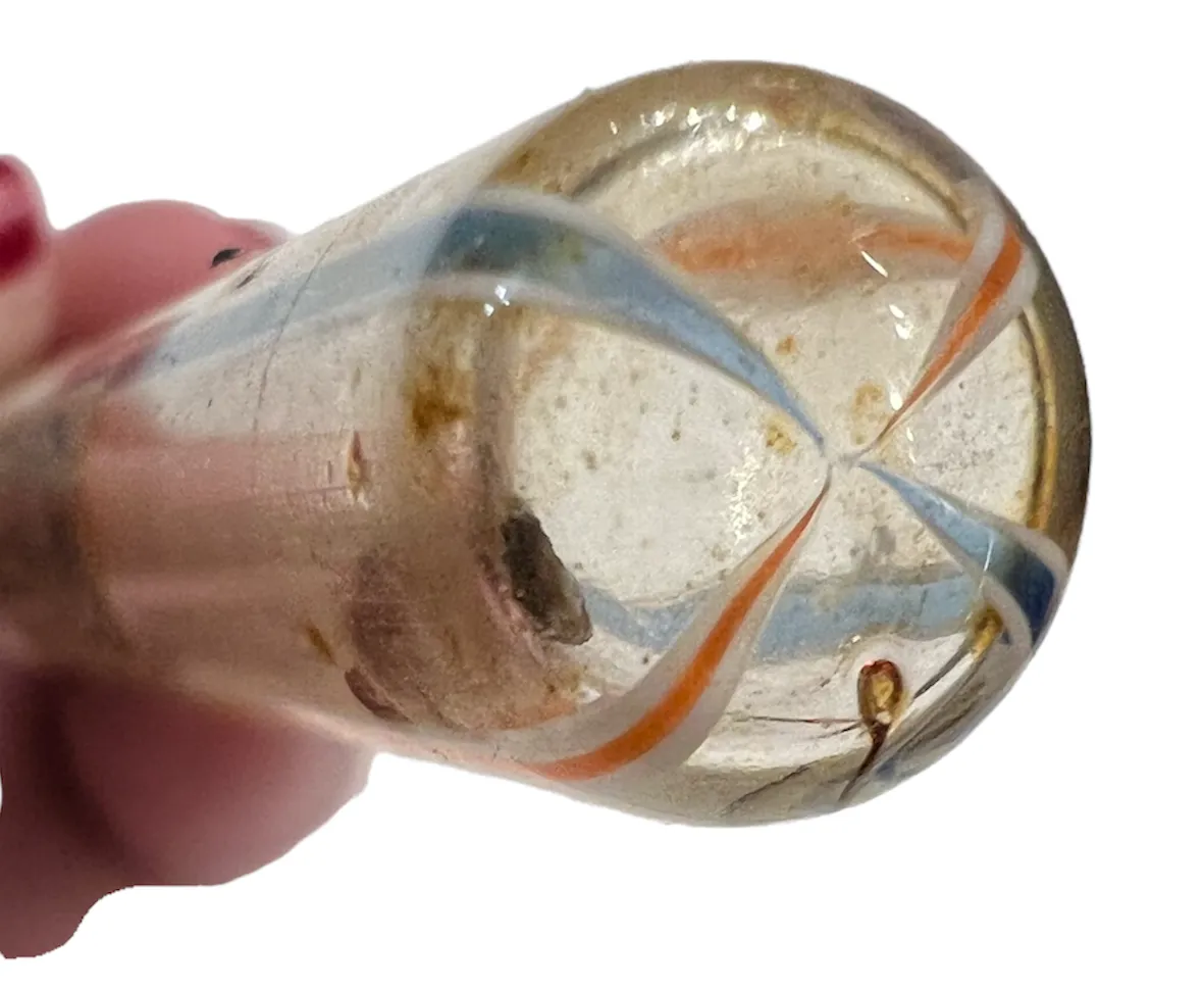 Antique perfume bottle featuring decorative shape and bright colors, set in a gentle background.