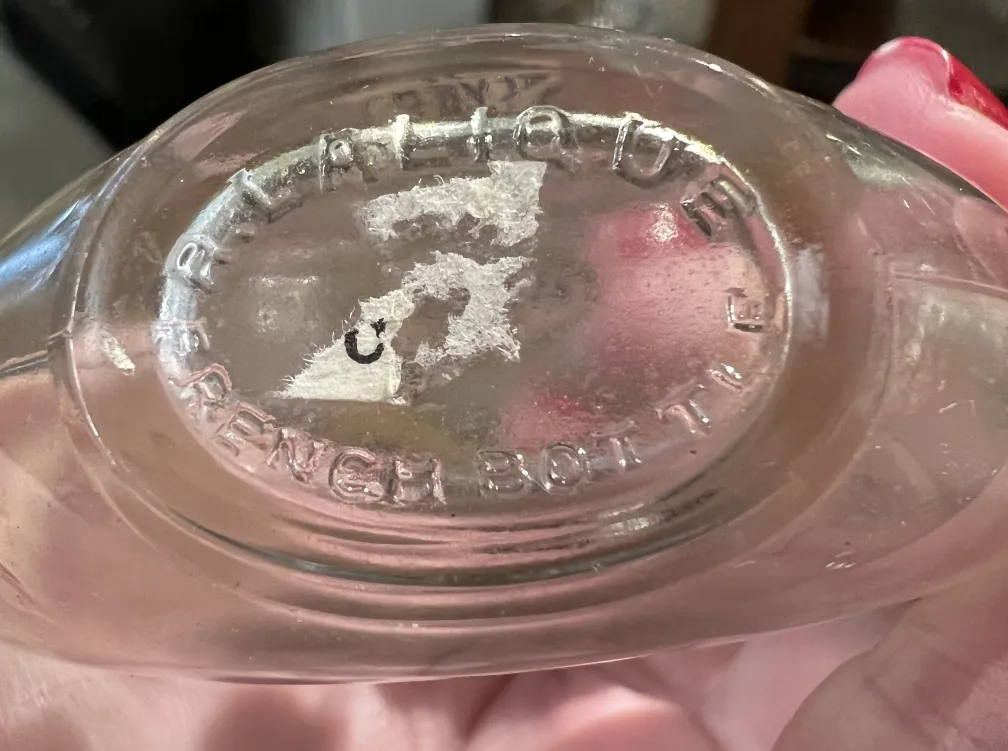 Antique French perfume bottle with classic features.