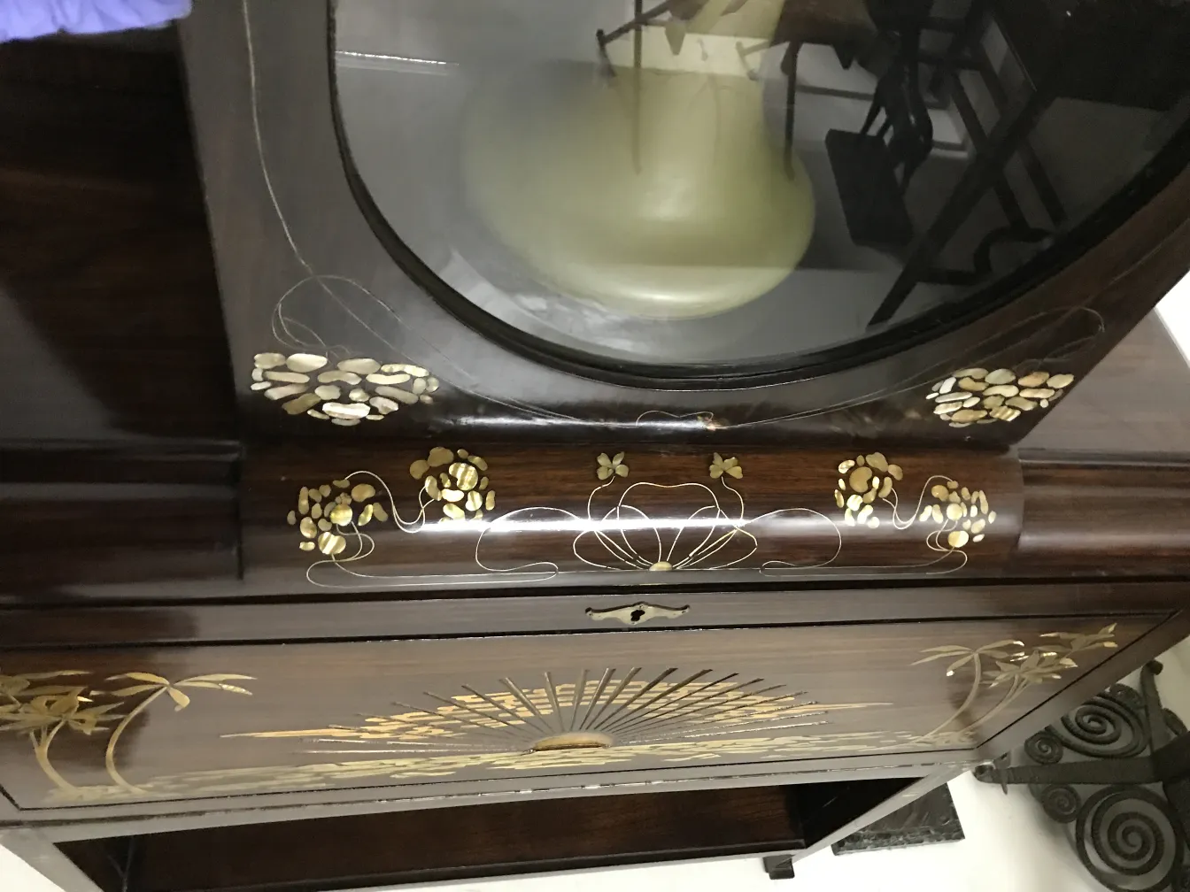 antique display cabinet with floral decoration and elegant shapes