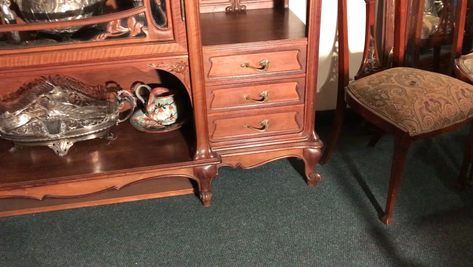 Antique display cabinet featuring decorative bottles and vases.