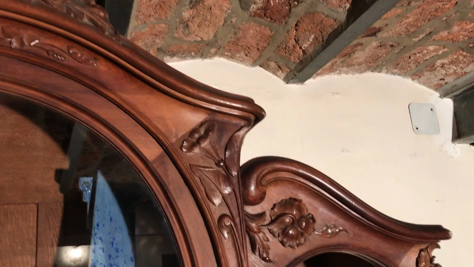 Antique display cabinet with handcrafted details in a rustic setting