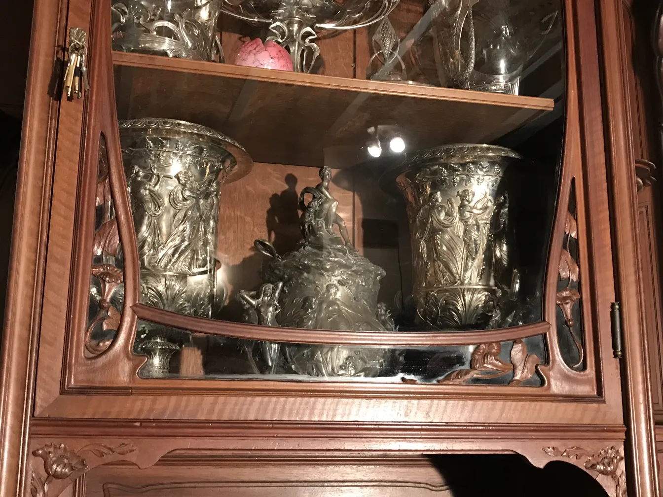 antique display cabinet with decorative items and fine details