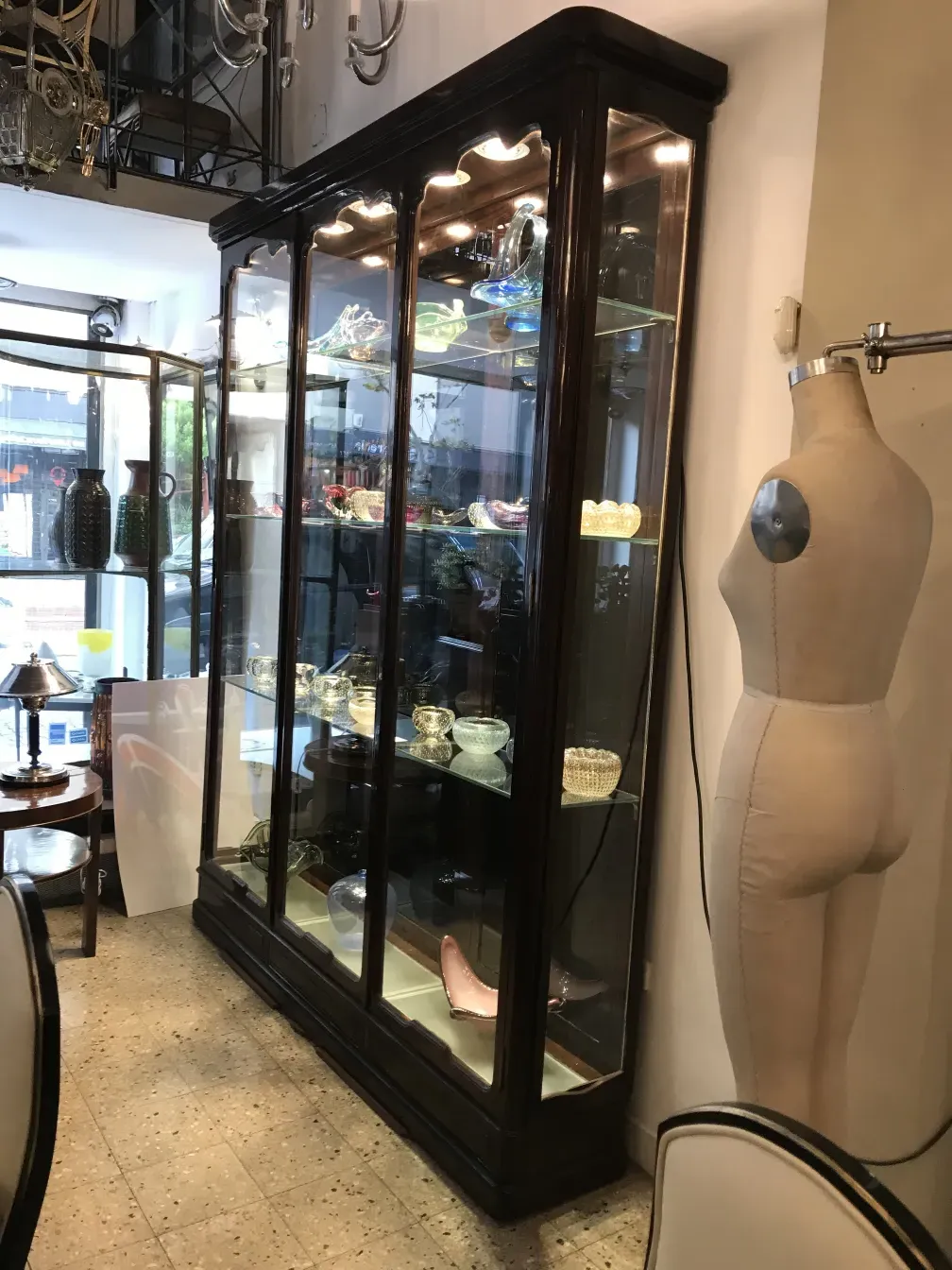 antique display cabinet with lights and decorative items inside