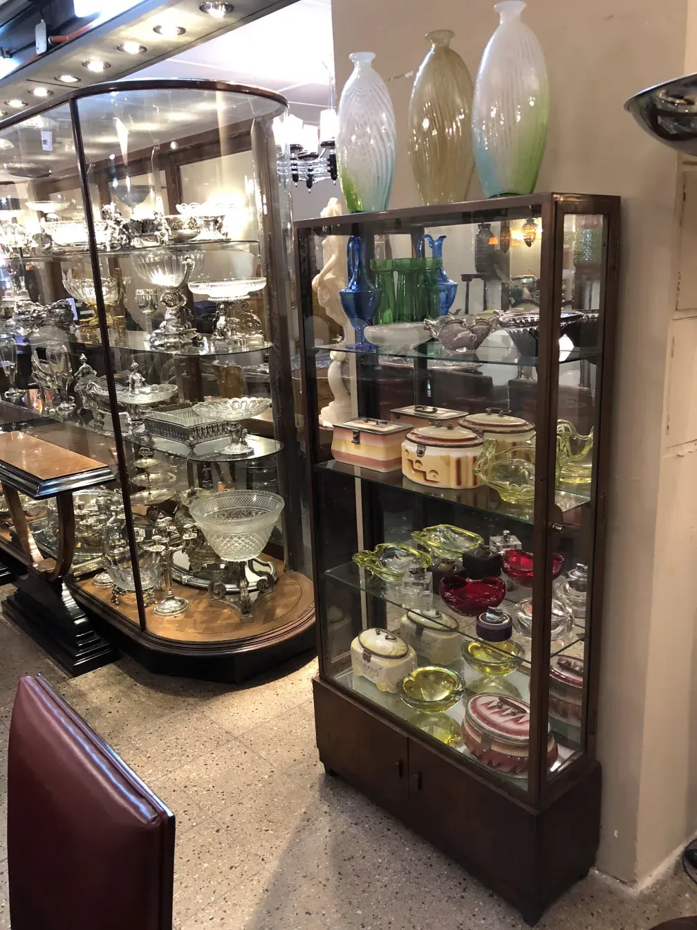 Antique display cabinet showcasing various decorative items.