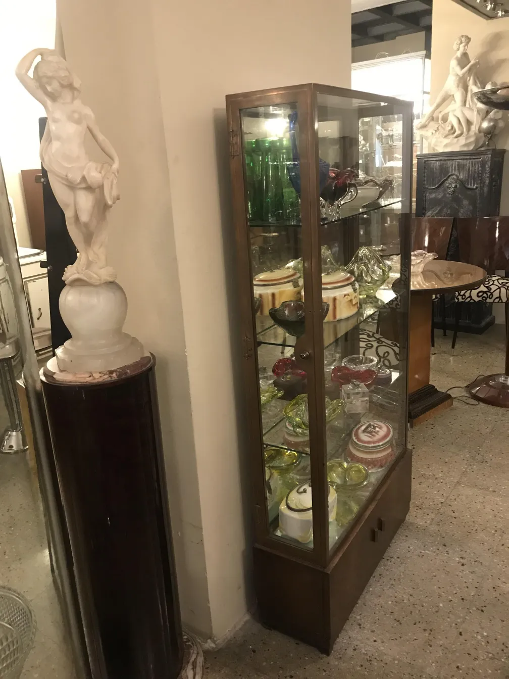 Antike Vitrine mit dekorativen Details und Sammlerstücken.