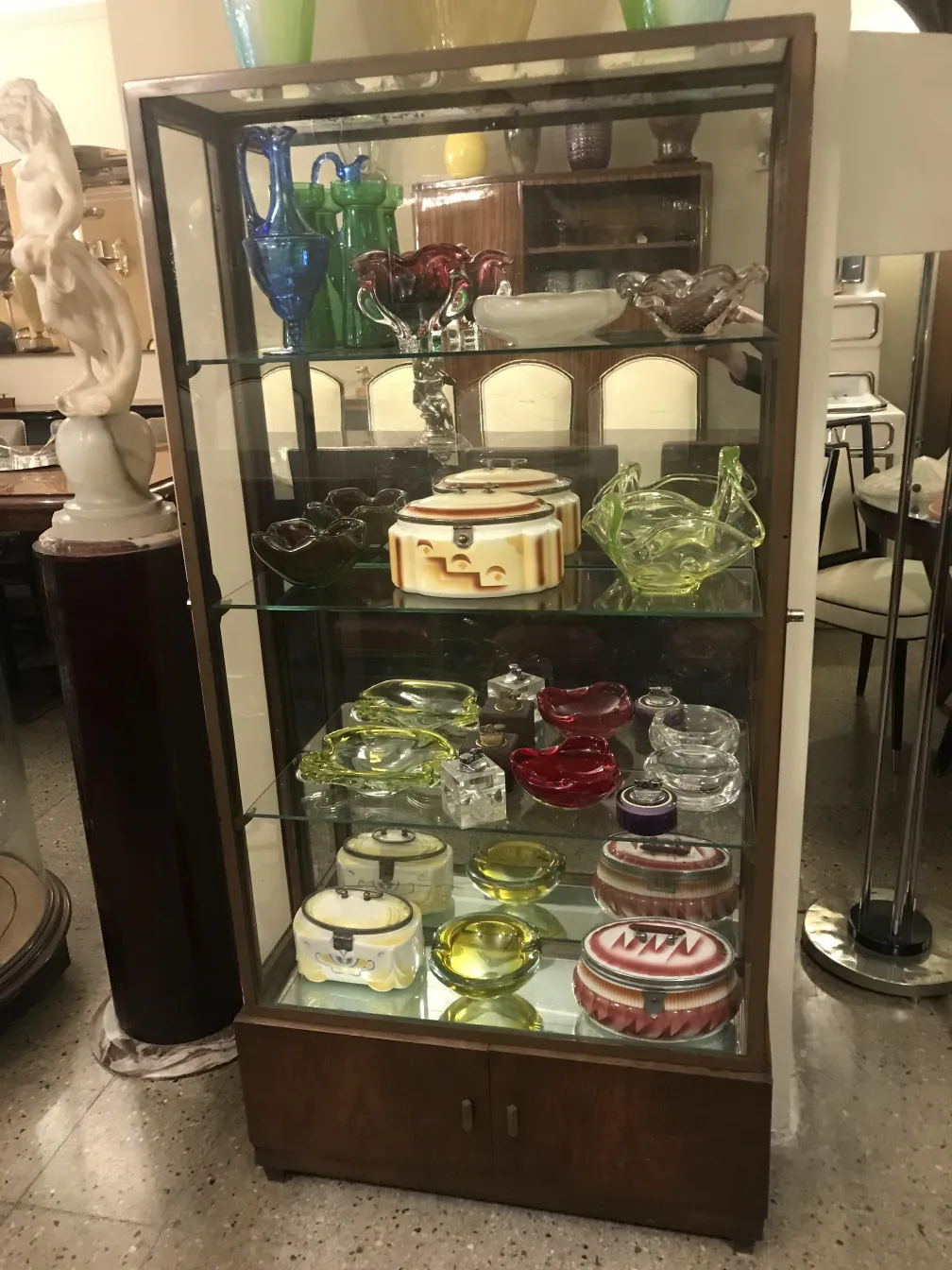 antique display cabinet with multiple shelves and decorative items