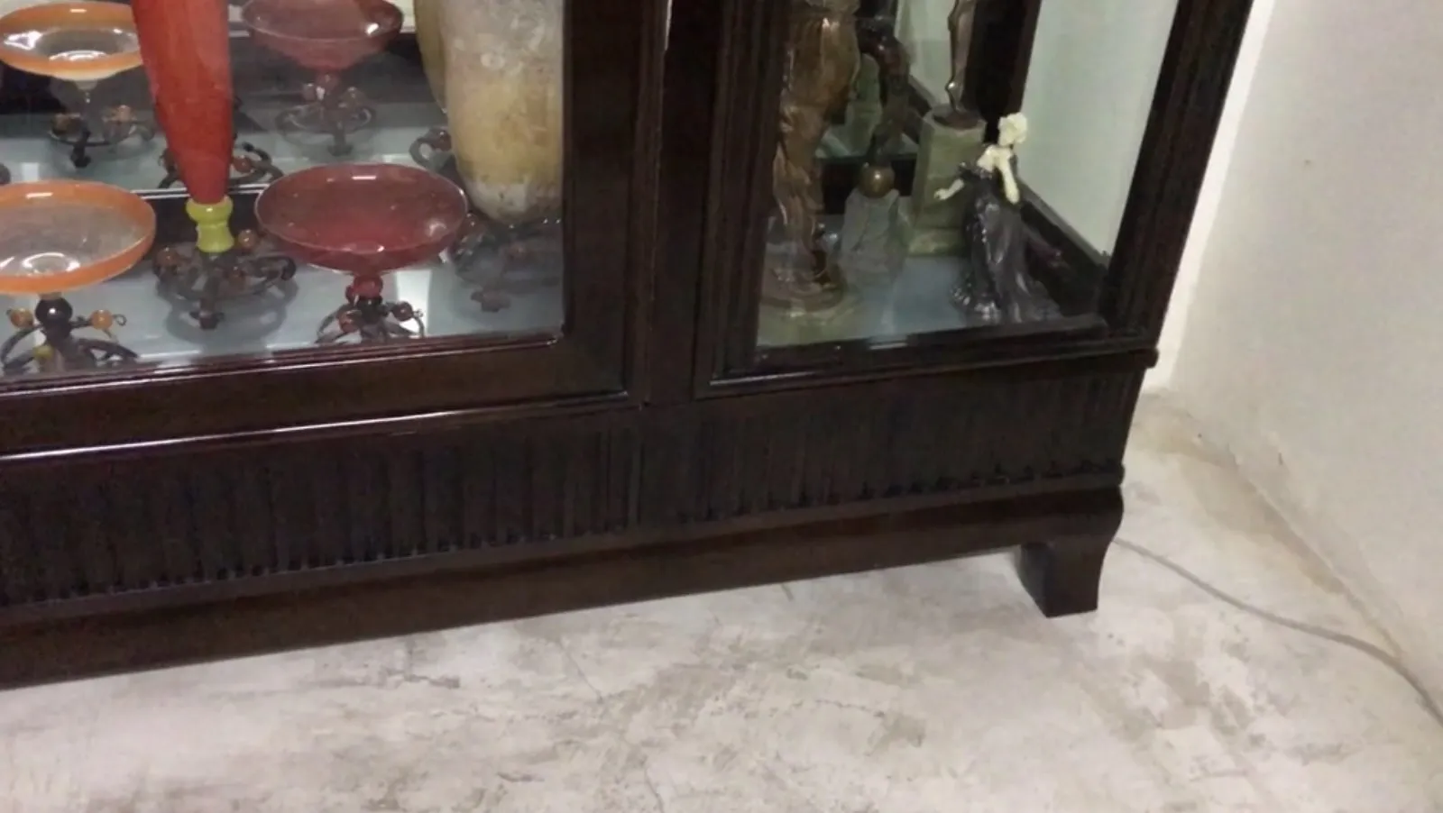 antique display cabinet with various decorative items inside