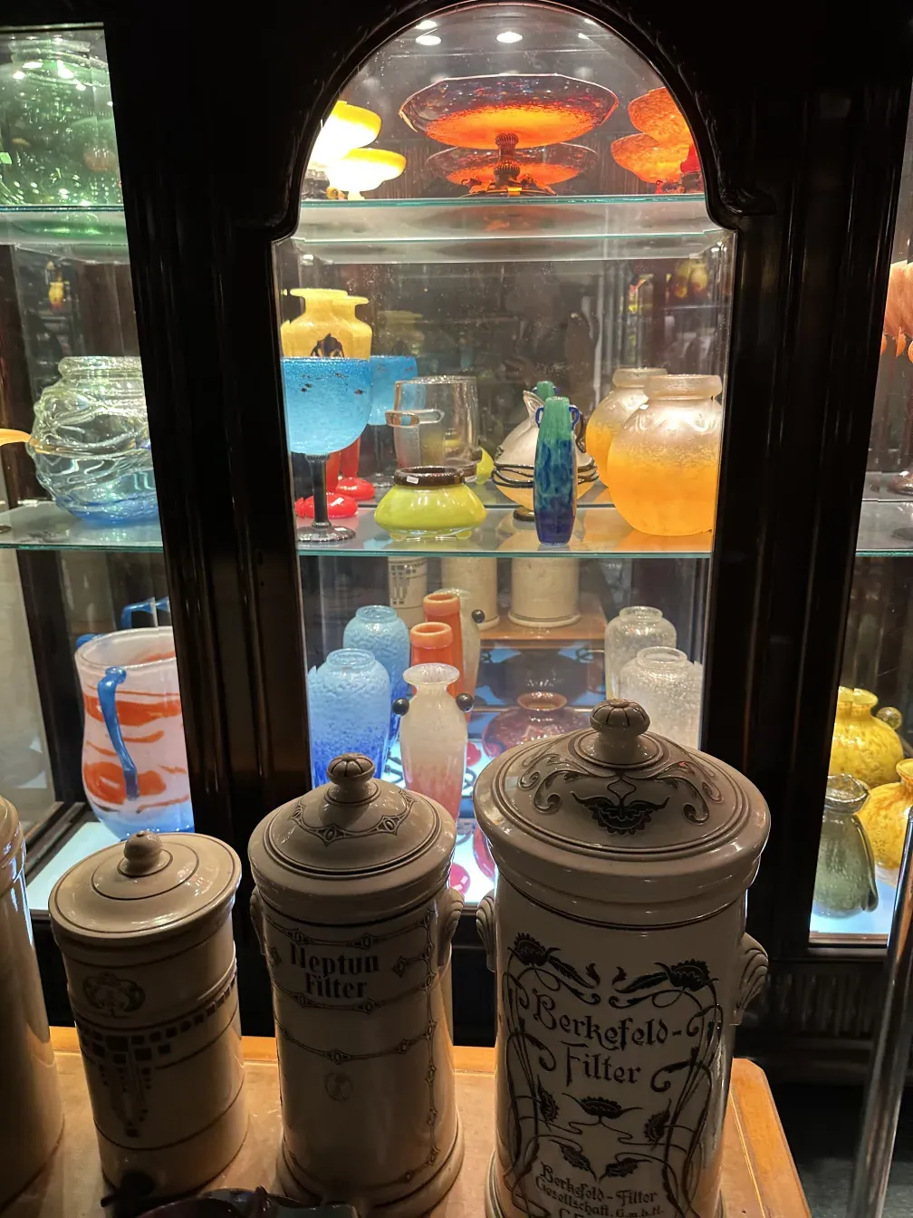 Vitrine antique avec divers objets colorés à l'intérieur