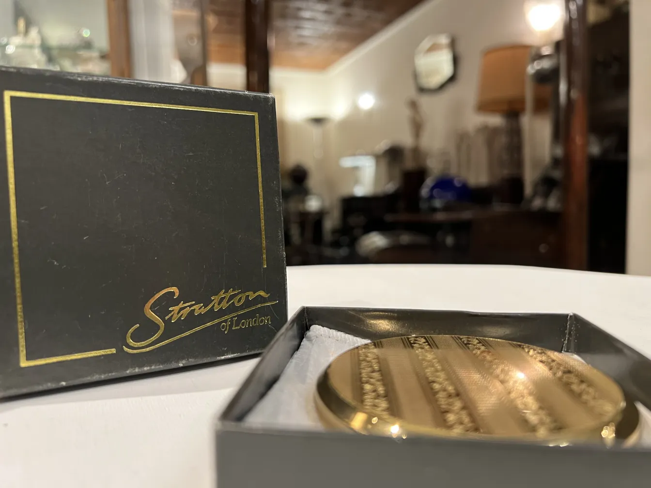 antique compact with a golden design inside