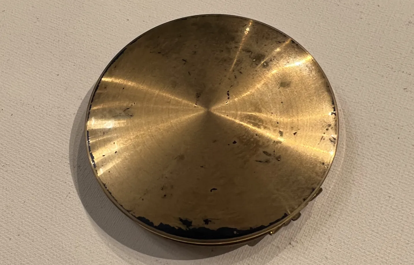 antique golden compact with worn details