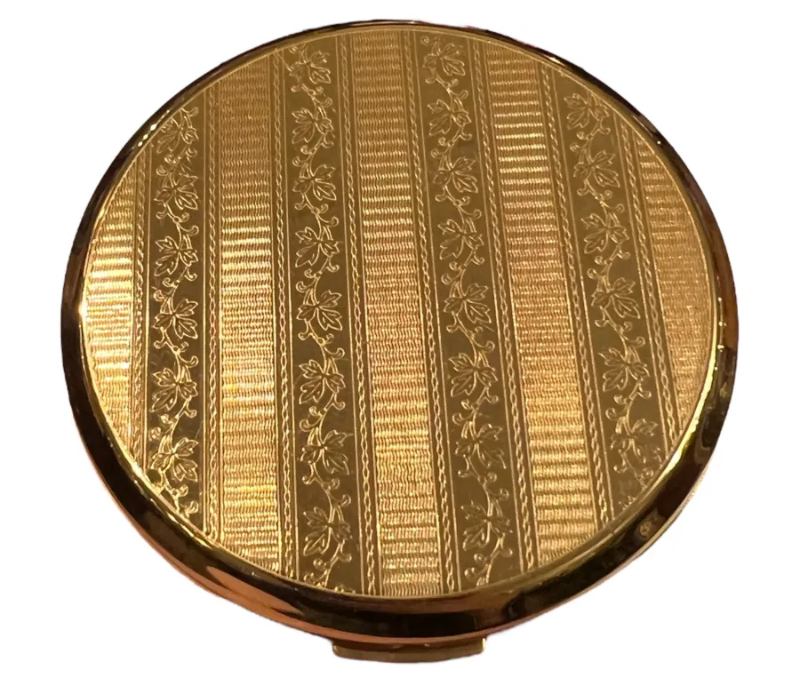 Antique compact with elegant design and intricate gold details