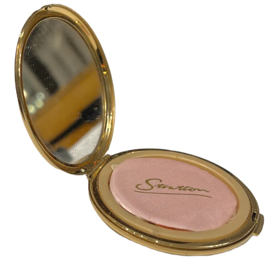 polvera ancienne ouverte avec miroir et applicateur rose