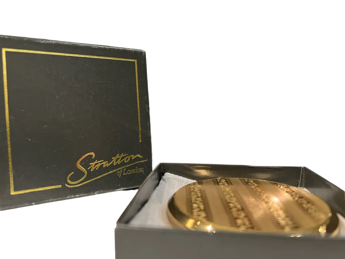 Polvera antica dorata con design a strisce, elegante