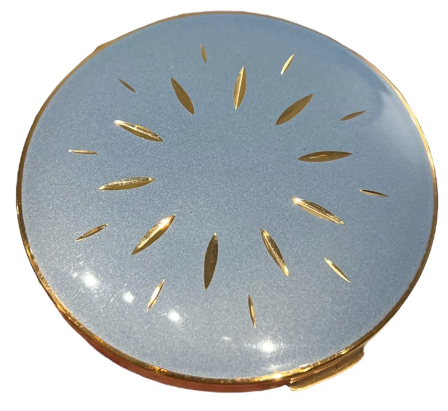 antique compact with decorative design in blue and gold
