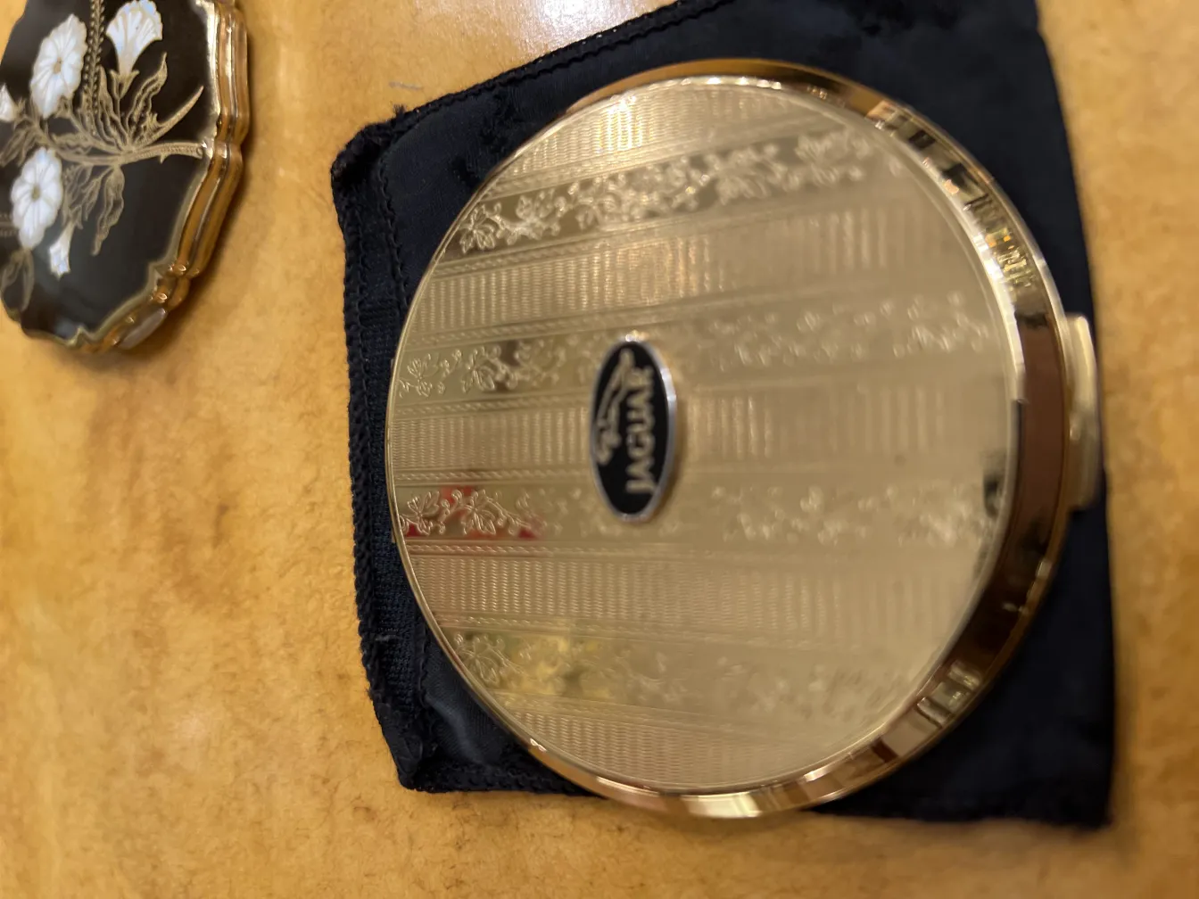 antique compact with beautiful golden design, cozy setting