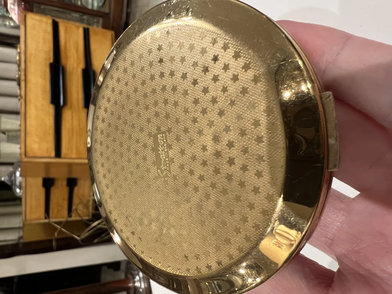 gold antique compact with decorative pattern