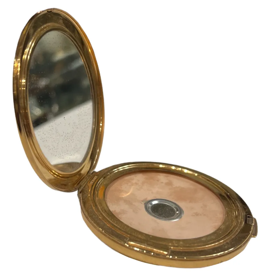 open antique compact with mirror and light powder inside