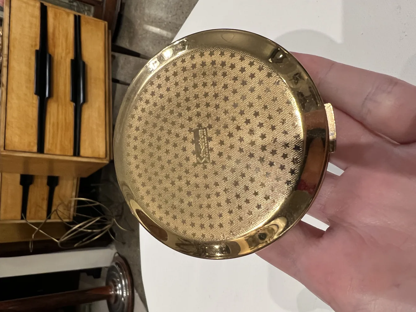 Antique compact with decorative design and visual details