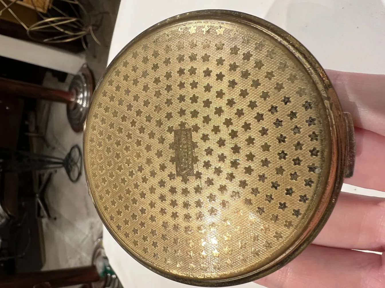 antique compact with golden star design