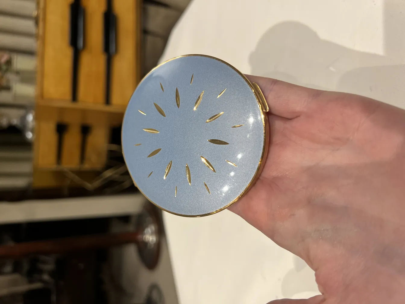 vintage compact with gold details and shiny finish