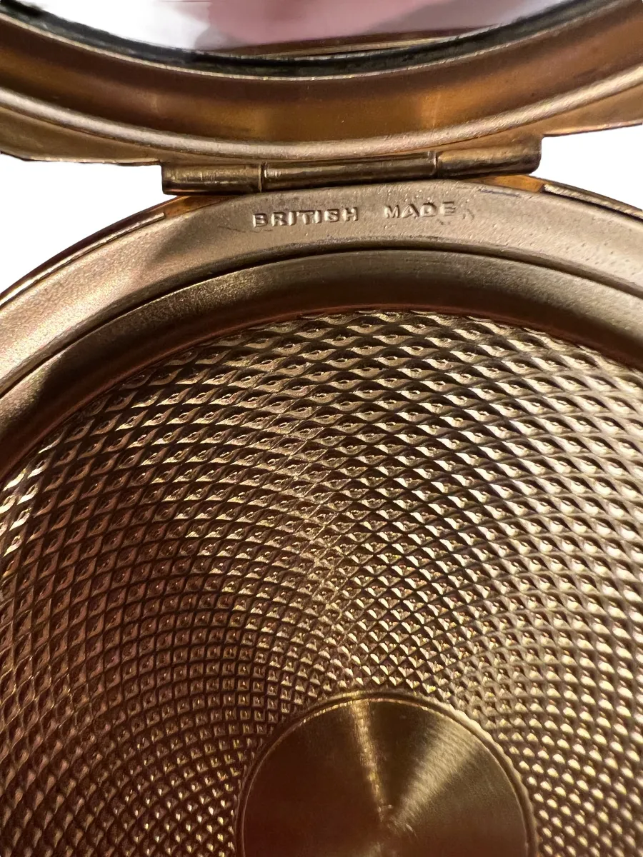 antique compact with embossed design and label