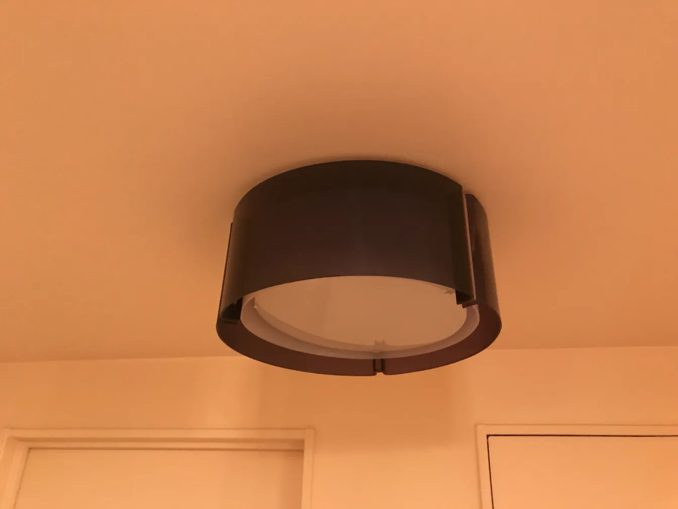 antique ceiling light fixture in a room with decorative edge