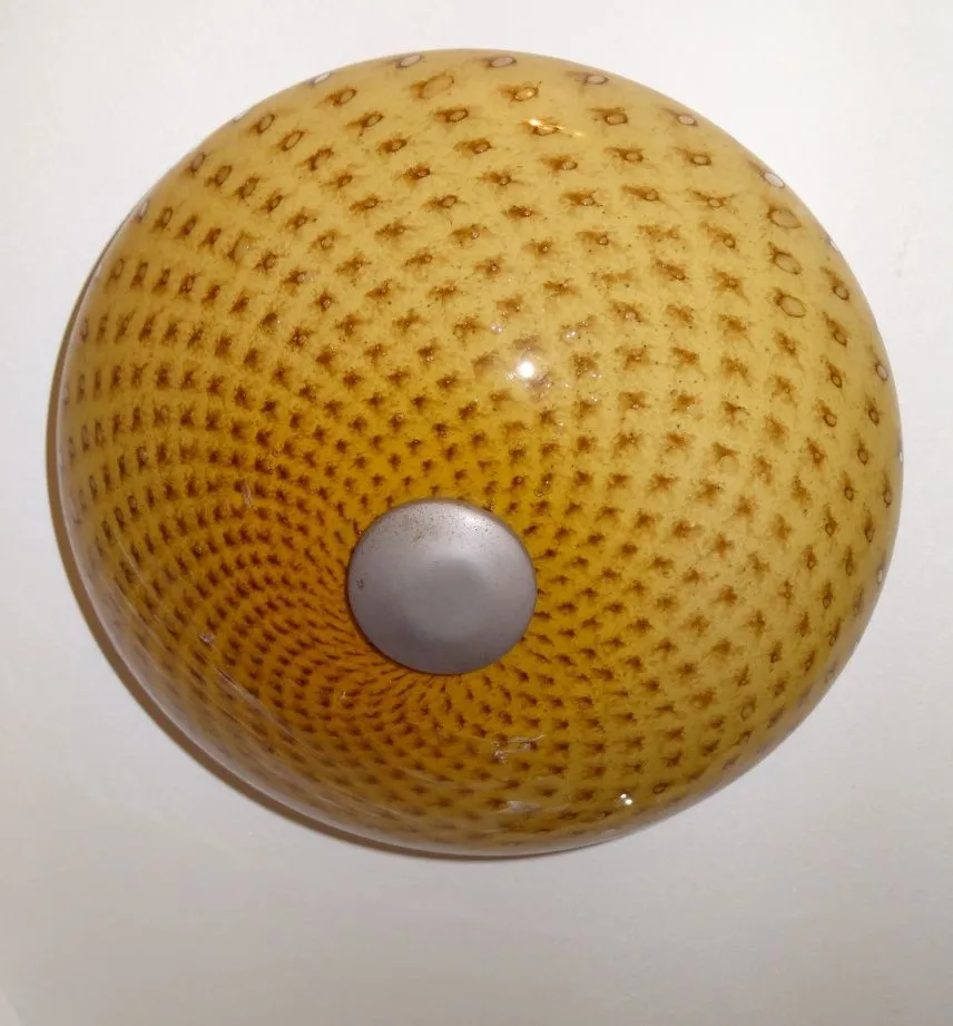 antique ceiling light with decorative pattern and warm glow