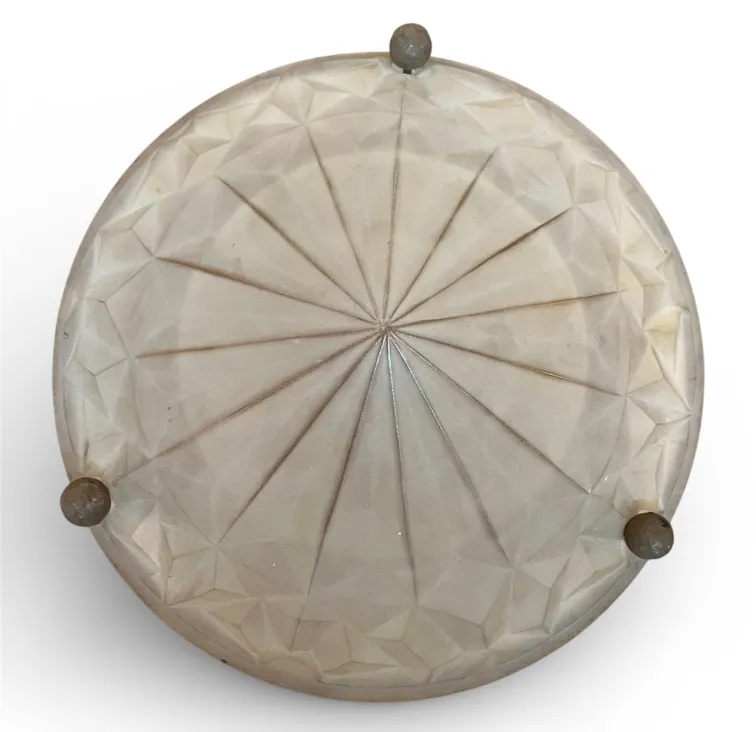 Antique ceiling light with decorative design, soft illumination.