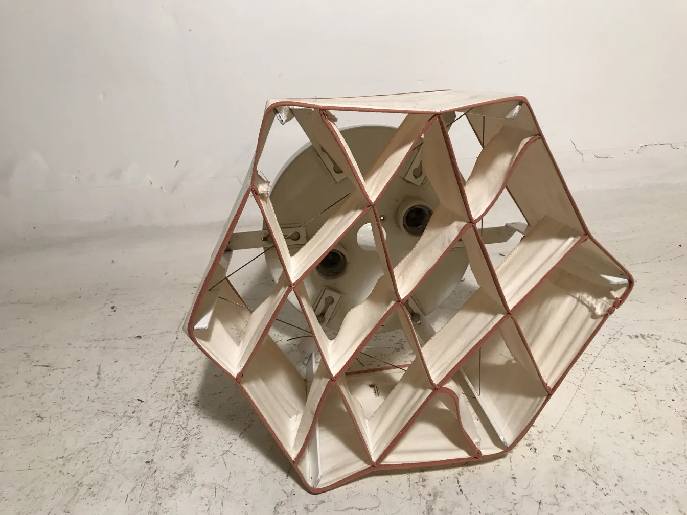 2 geometric design ceiling lights, antique style, in a neutral setting.