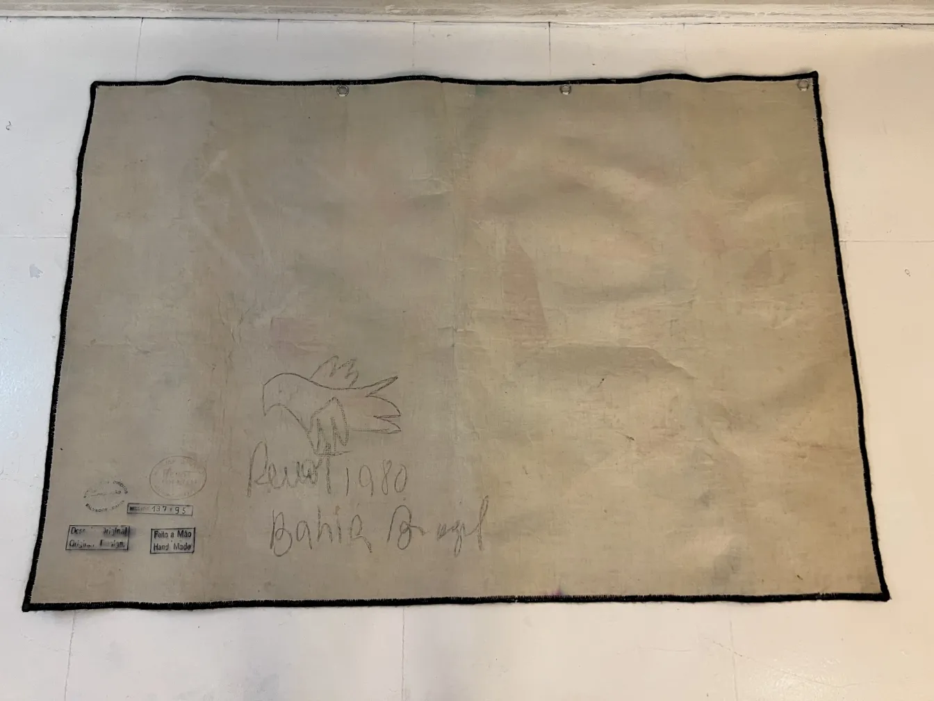 antique tapestry with bird embroidery on light background