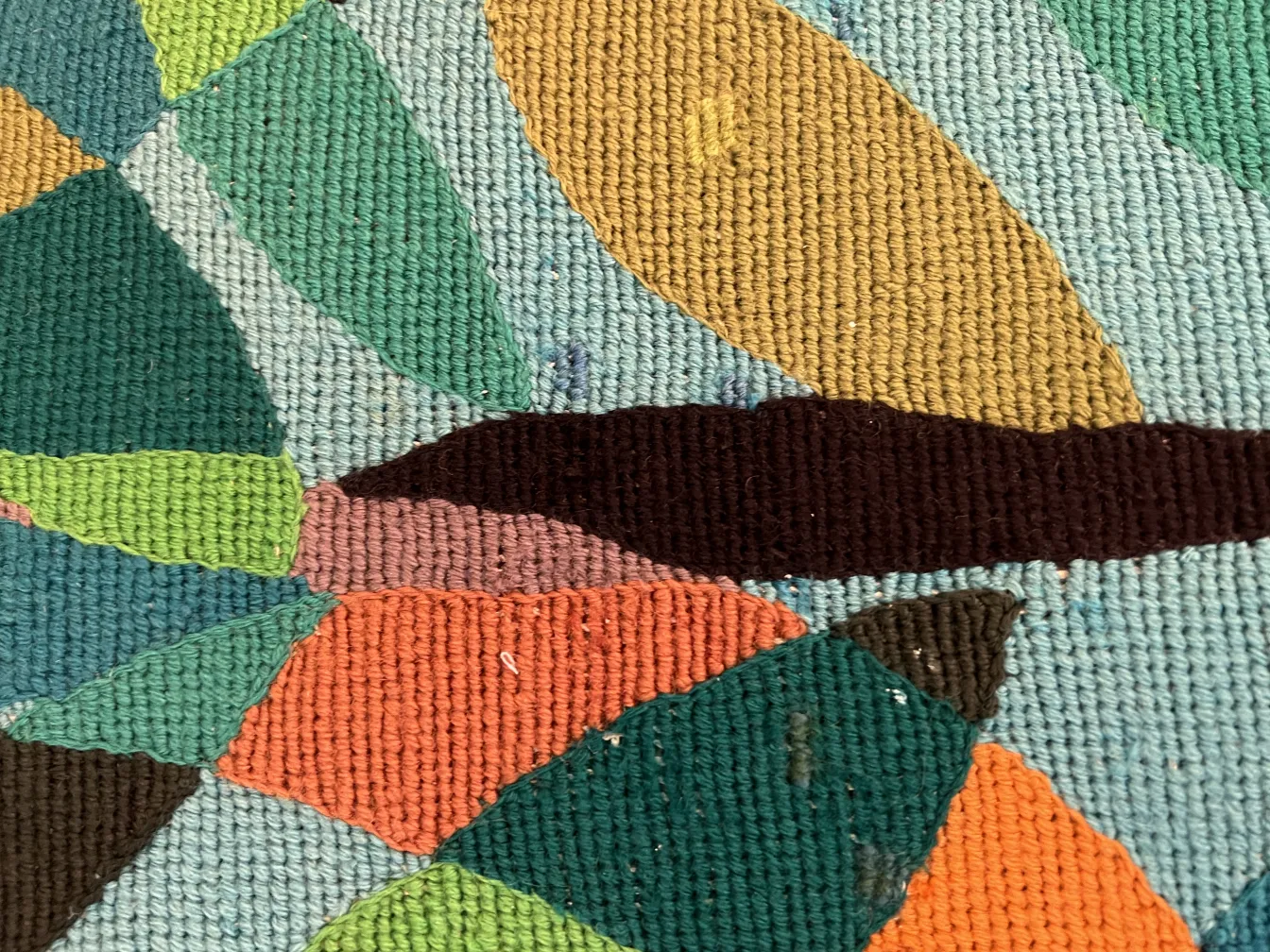 antique tapestry with colorful shapes in various tones