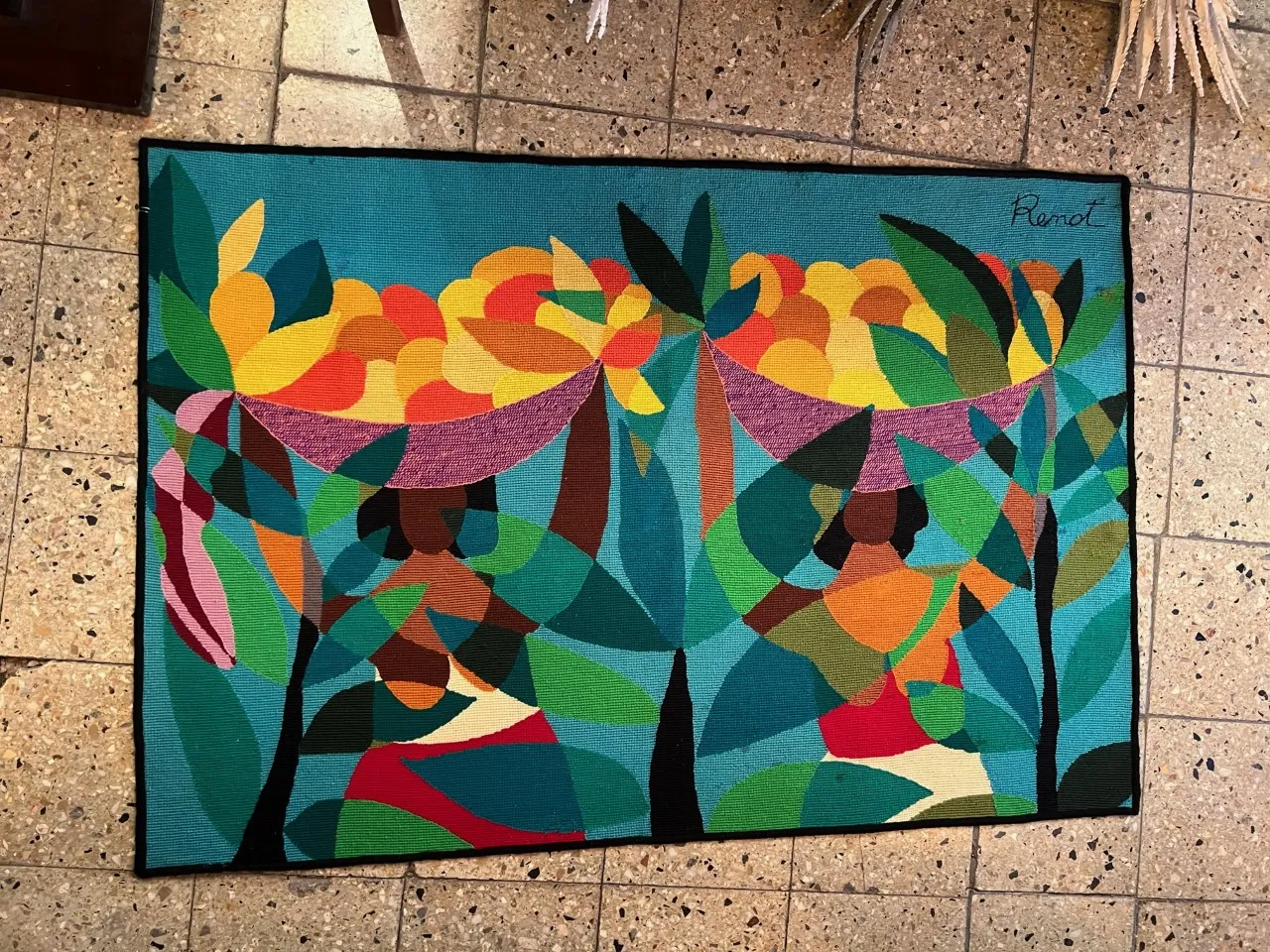 Antique tapestry with figures and vibrant colors in a colorful setting