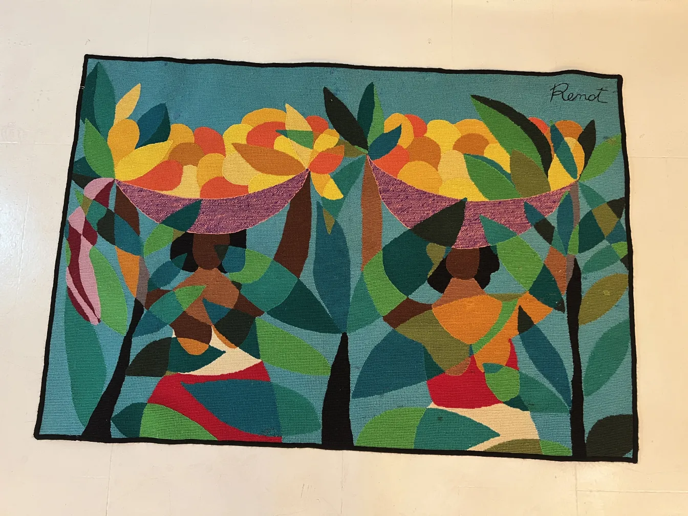 antique tapestry with bright colors and human shapes in the setting