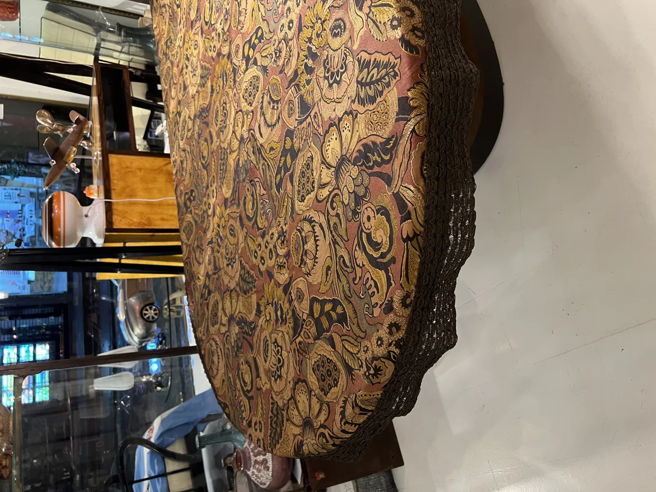 antique tablecloth with a bright floral design on a table