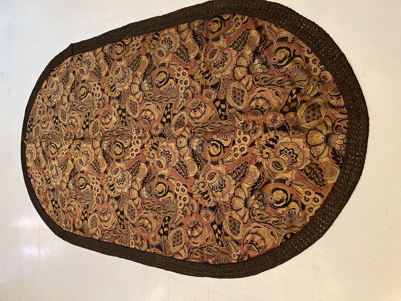 antique tablecloth with a colorful floral pattern on a light background