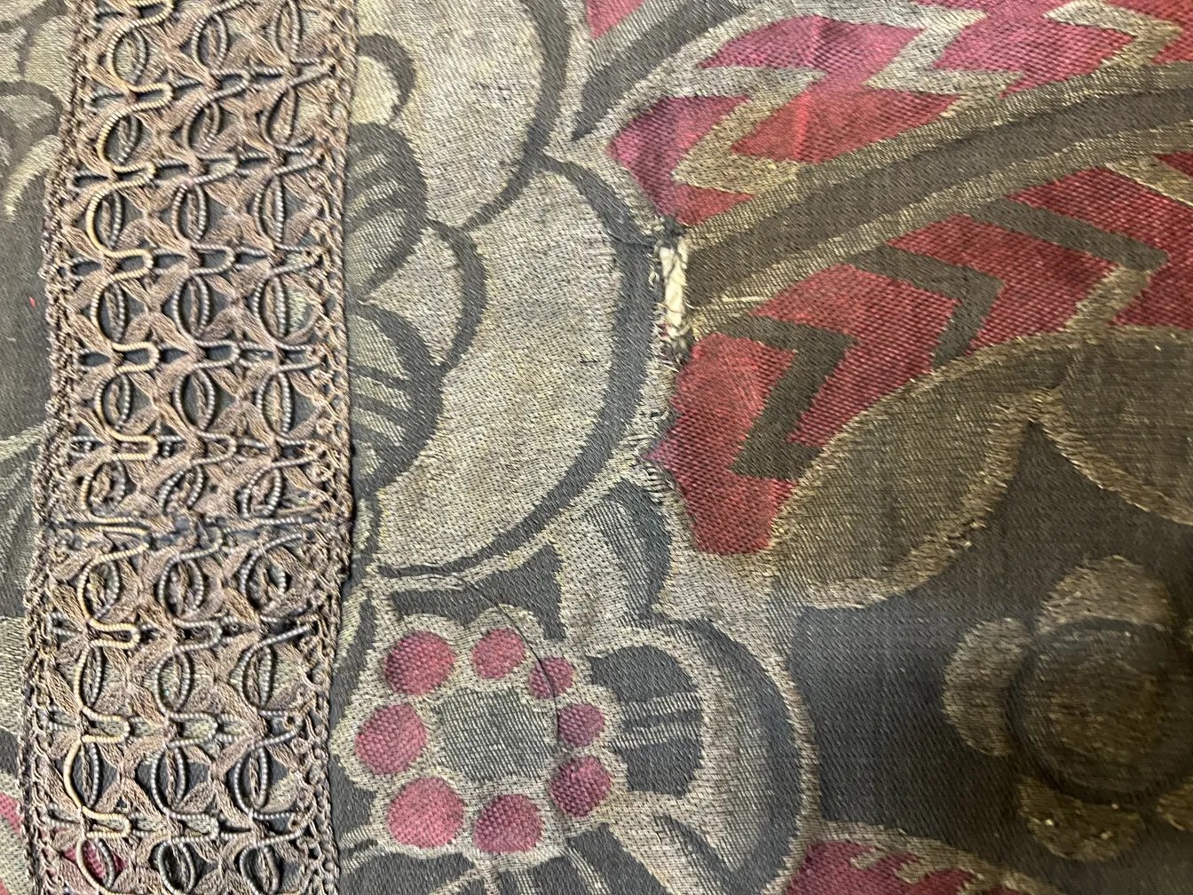 antique tablecloth with floral design on a table