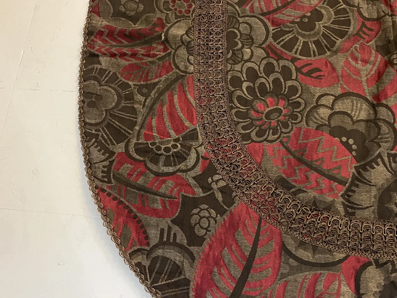 antique tablecloth with a colorful floral design and edges