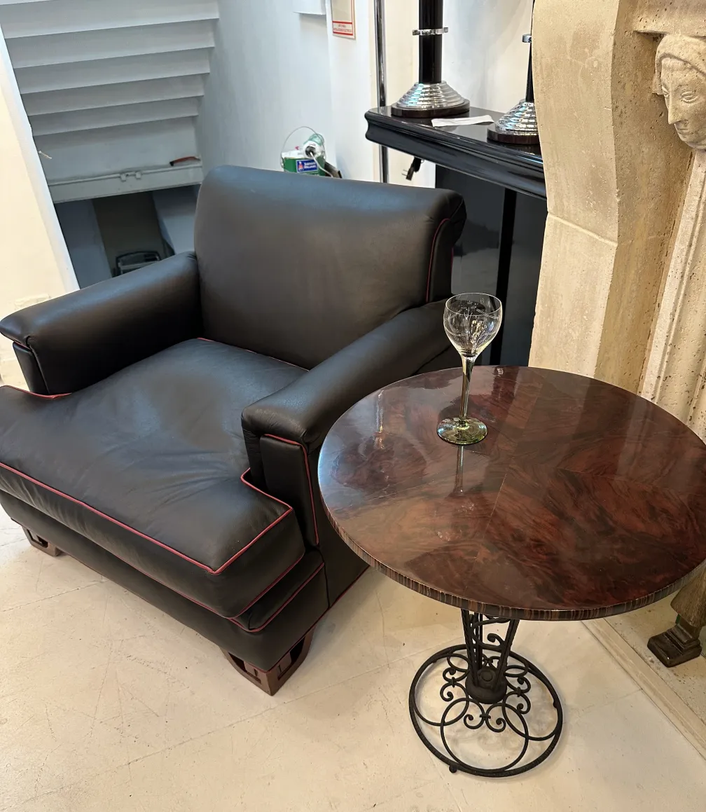 two antique glasses on a round table with a sofa